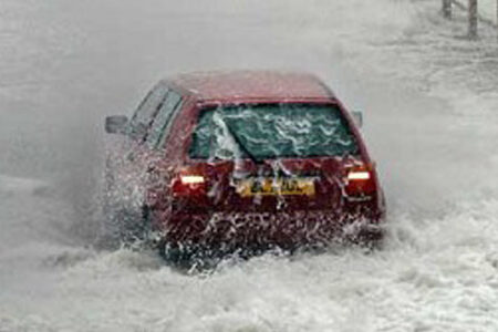 Car driving through flood