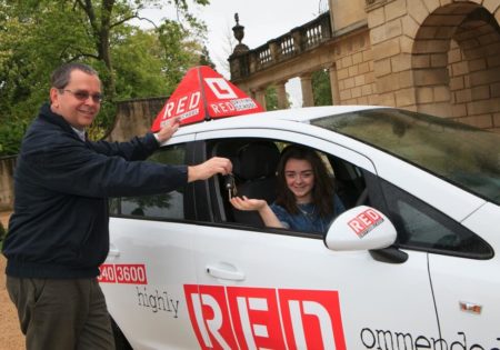 Dave Childs handing car keys to Maisie Williams