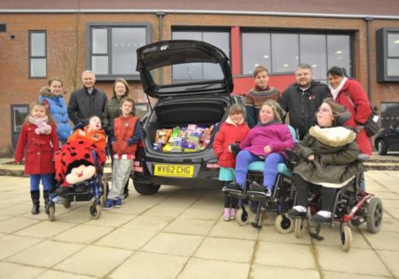 Grace House Hospice children outside with presents in boot of car