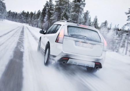 White car driving in snow