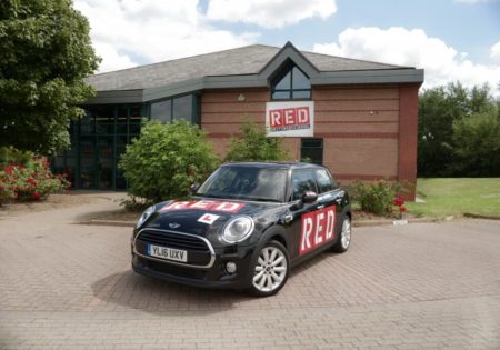 RED black mini parked outside red driving school