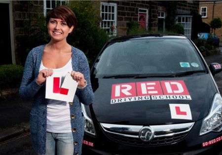 woman ripping up learner driver plate