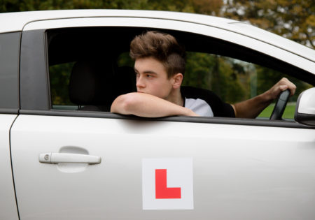 Young man learning to reverse car