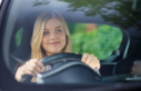 Woman smiling while driving