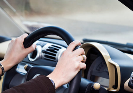 Hand on steering wheel