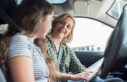 Driving instructor with learner in car