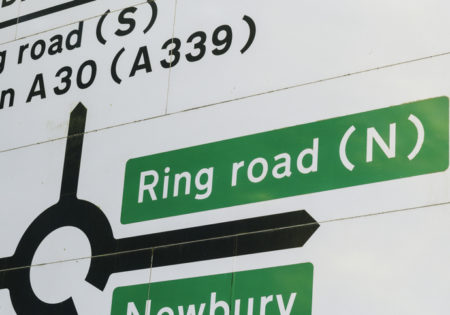 Road sign showing directions to Ring Road from a roundabout