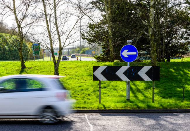 Day view of busy traffic on UK Motorway roundabout