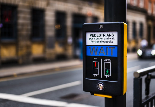 Yellow and black pedestrian crossing button
