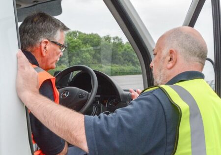 two men talking in a lorry