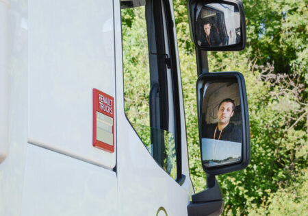 man looking in lorry mirror