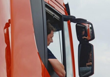 man in lorry checking mirrors