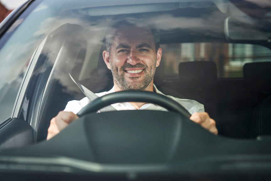 Driving instructor smiling at wheel