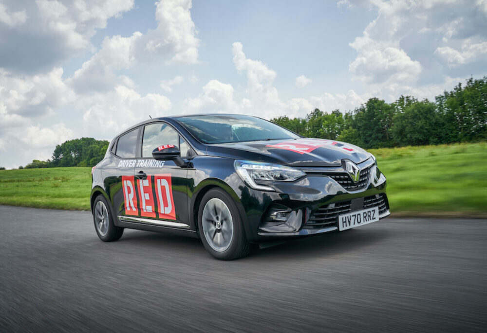 Red driving school instructor car