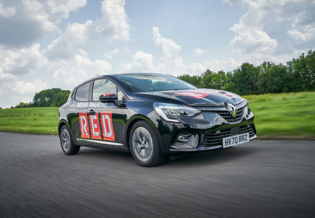 Red driving school instructor car