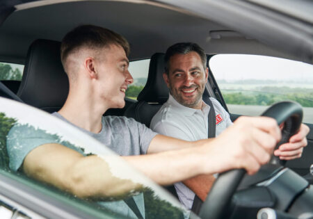 Male learner and instructor smiling