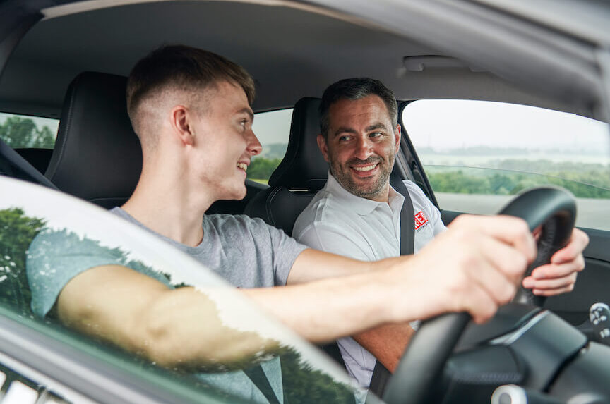 Male learner and instructor smiling