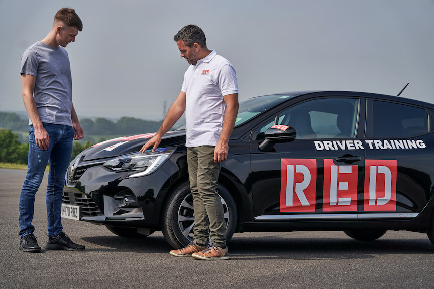 Instructor pointing at bonnet