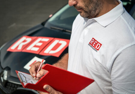 Driving instructor writing on clipboard