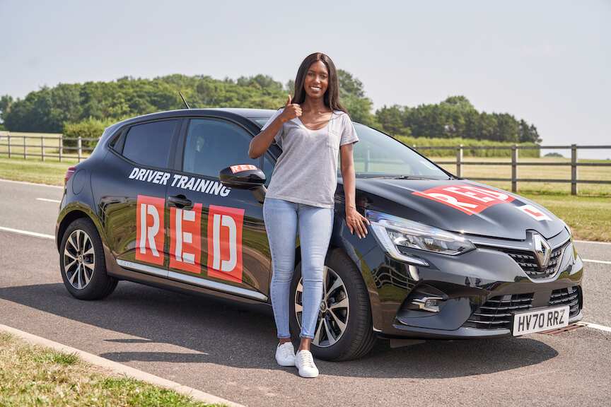 Female standing beside car