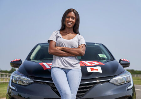 Woman resting on car